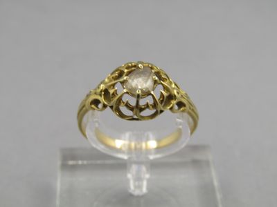 an image of a gold ring with a white diamond in the center
