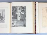 three open books on a table with pictures on them