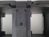 a close up of a black plastic object on a white surface
