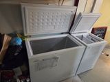 two freezers sitting next to each other on the floor