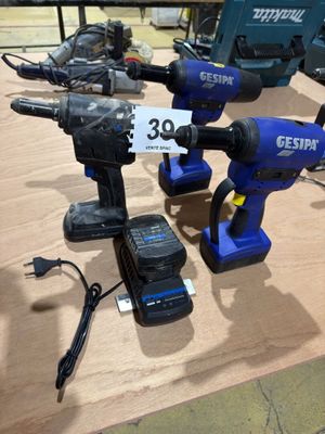 three electric tools sitting on a table with a price tag