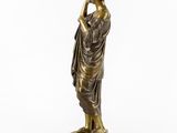 a bronze statue of a woman holding a flower in her hand