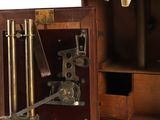 a small wooden box with a microscope inside of it