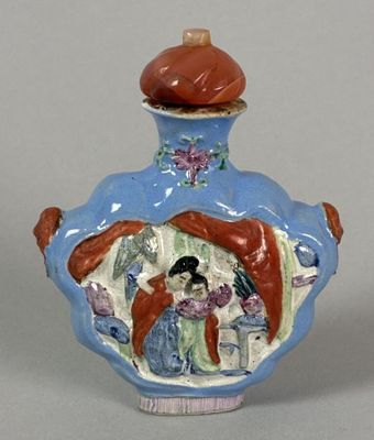 a small blue vase with a painting on it
