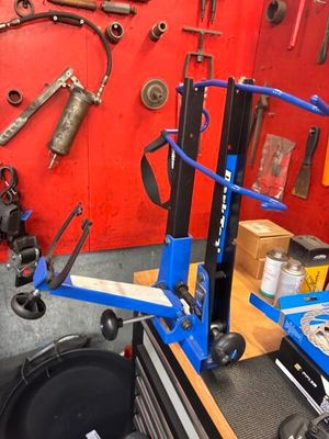 an image of a mechanic ' s workshop with tools on the wall