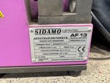 a close up of a pink machine with a sticker on it