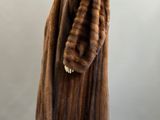 a woman ' s brown fur coat on a mannequin mannequin mannequin mannequin mannequin mannequin mannequin manne