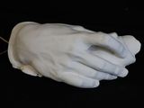 a close up of a white hand holding a string