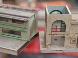 two model buildings sitting on a red table