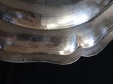 a silver plate that has been placed on a black table