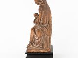 a statue of a woman holding a child in her lap