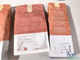three bags of coffee sitting on top of a table next to each other