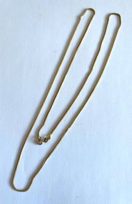 Collier à chaîne en plaqué or avec fermoir, sur fond blanc