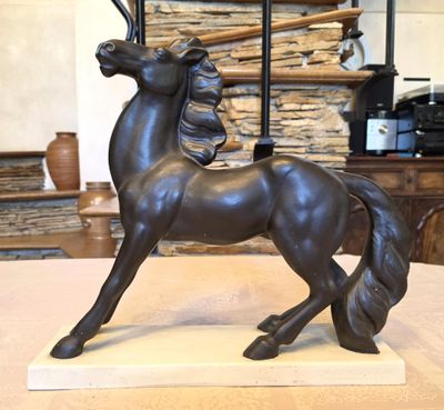 a statue of a horse that is standing on a table