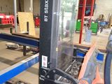 a fork lift in a warehouse with boxes on the floor