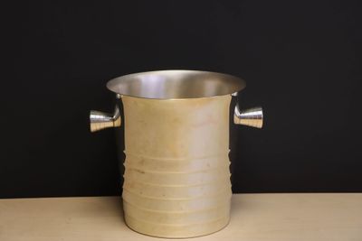 a metal bucket that is sitting on a table