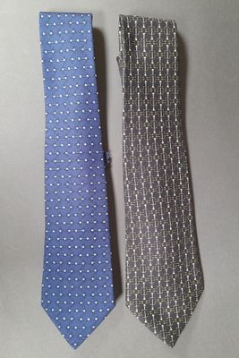 two ties that are sitting next to each other on a table