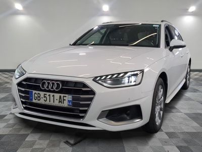 the white audi is parked in a large room with checkered flooring