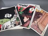 three comics are stacked on top of each other on a table