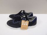 men ' s navy blue sneakers with white soles and a tag that says mr land