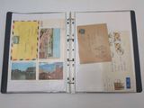 an open book with a bunch of postcards on it
