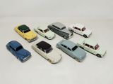 several toy cars are lined up in a row on a white surface