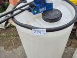 a white bucket with a blue pump on top of it next to a white bucket with a blue pump on it
