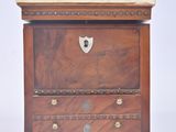 a small wooden chest of drawers with a metal handle