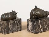 two statues of animals that are sitting on top of each other