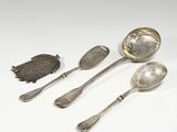 three silver spoons and a teaspoon on a white surface