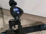 a scooter that is sitting on the ground in front of a garage door