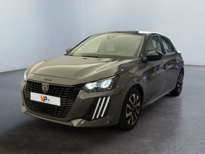 the grey car is parked in a large room with a black floor
