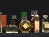 many different types of perfume bottles lined up on a table