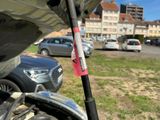 a stick stuck in the hood of a car