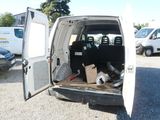 a white van with its doors open in a parking lot