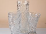 three glass vases sitting on a table next to each other