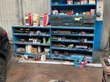 a picture of a car in a garage with a shelf full of tools