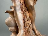 an image of a statue of a woman holding a vase