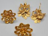 a set of three gold - plated flower earrings and a broochet