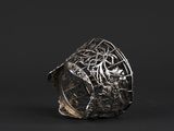 a close up of a silver ring on a black background