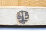 a close up of a piece of wood with a face on it