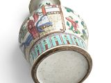 a small vase with a design on it on a white surface