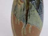 a brown vase with a blue and green design on it