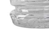 a clear glass jar with a lid on a white surface