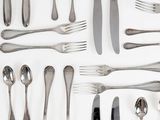 a lot of silver spoons and forks on the table