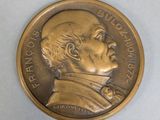 a close up of a coin with a man ' s face on it