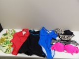 a white table topped with assorted clothing and a pair of flip flops