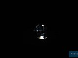 a close up of a diamond in the dark with a light shining on it