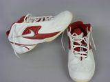 pair of white and red tennis shoes with laces on them