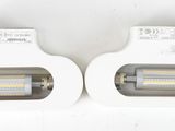 two light bulbs in a white box on a white surface
